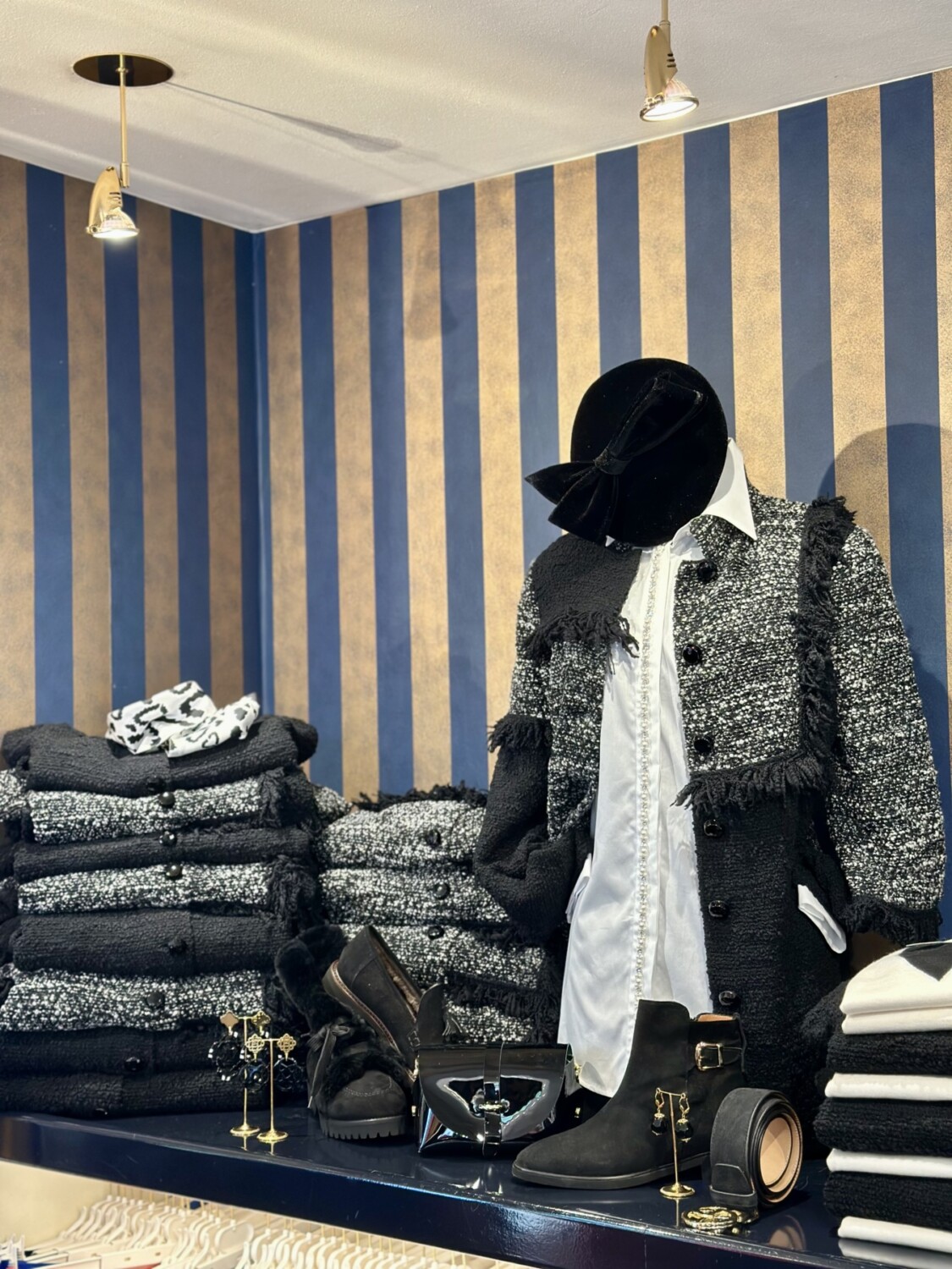 Elegant dameskleding en accessoires in een winkeldisplay met luxe texturen en stijlen.